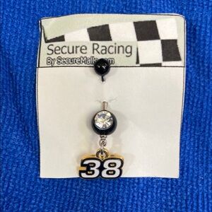 Secure Racing Black and Gold Number 38 belly button piercing.